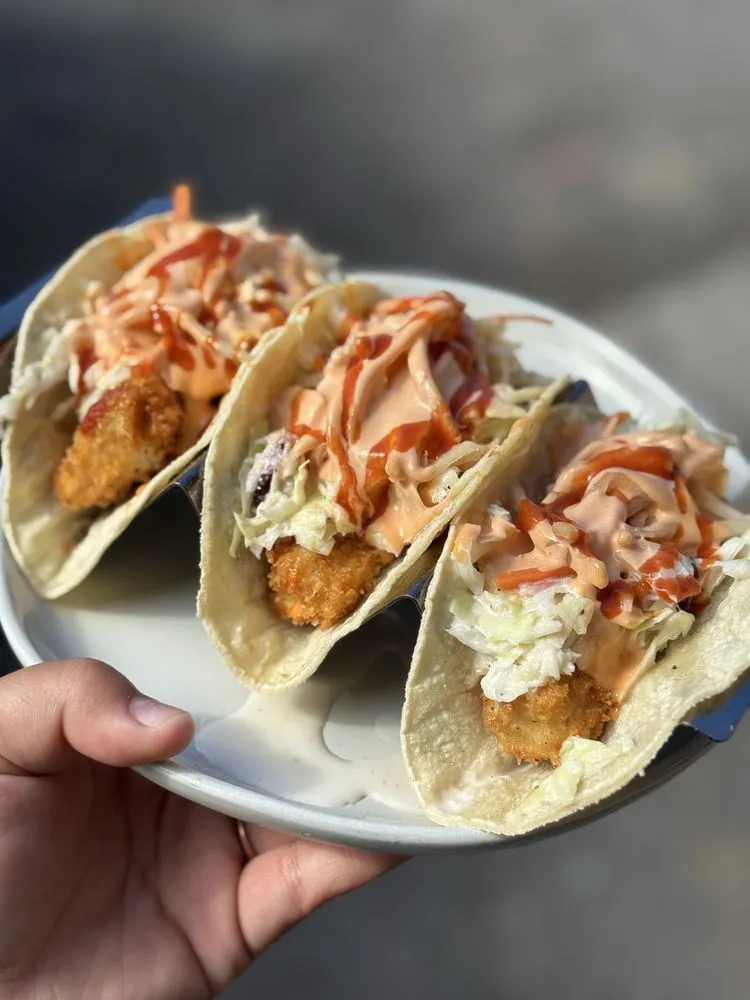 Crispy panko fish tacos with slaw and house sauce.