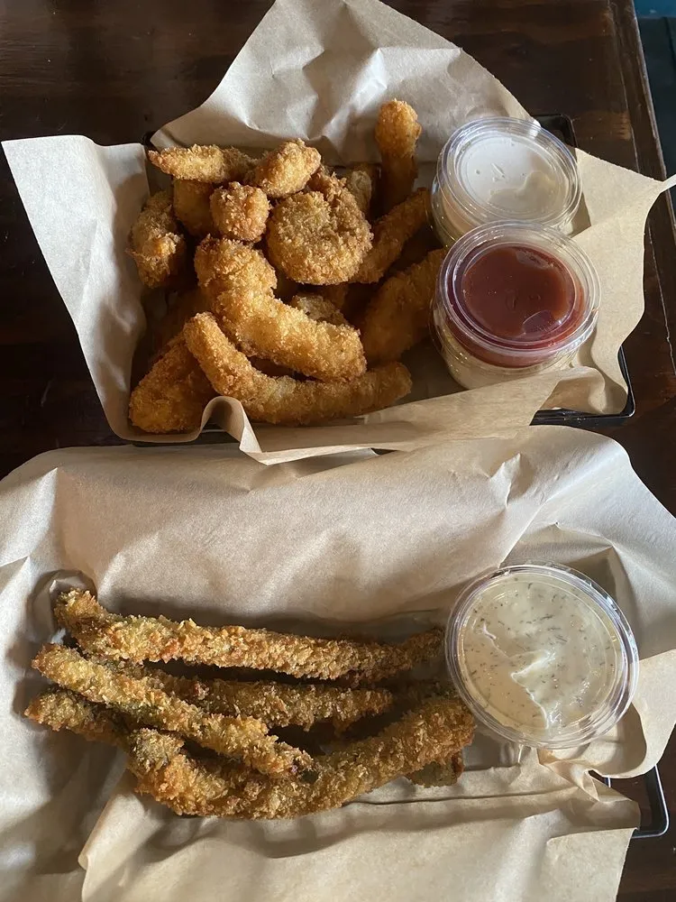 Two baskets of golden panko-fried seafood with house dipping sauces.