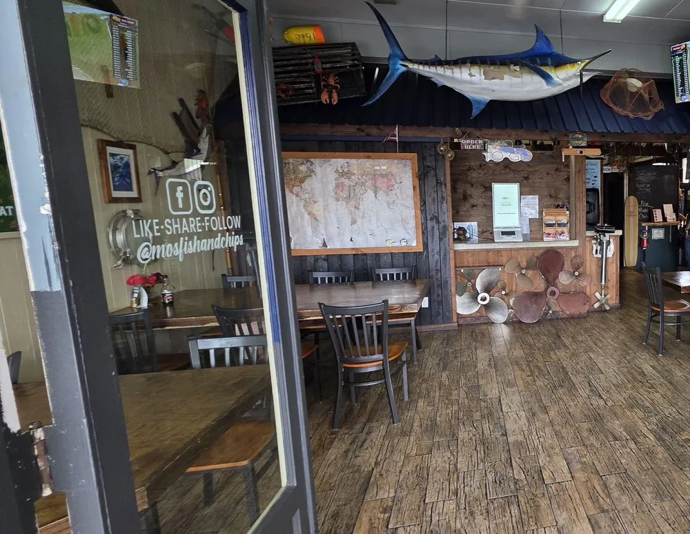 The weathered wood dining room at Mohala's with propellers on the wall and warm light.